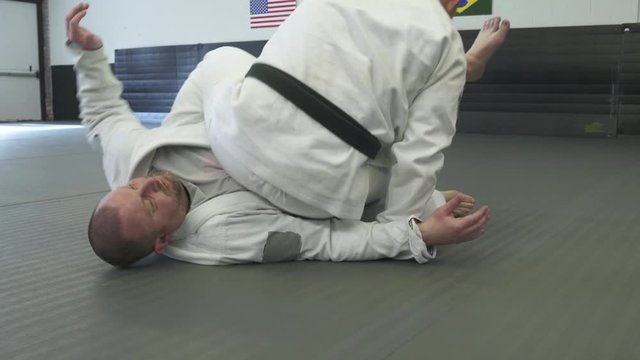 Mid adult men practicing Jiu-jitsu moves