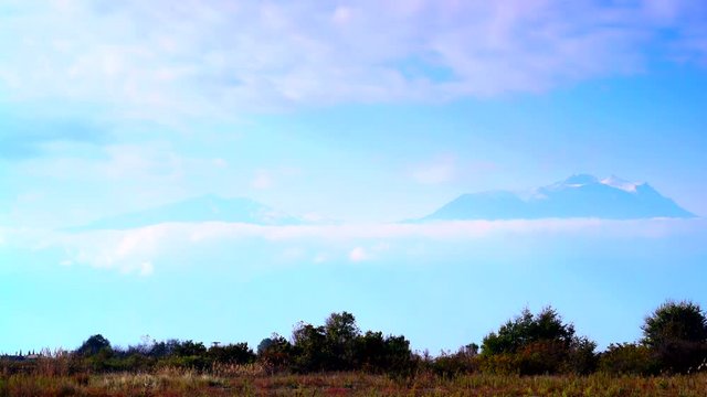 Mountains landscape view from distance. Blue sky with moving clouds over Mount Olympus, Greece. Time lapse