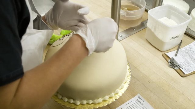 Baker decorating a cake
