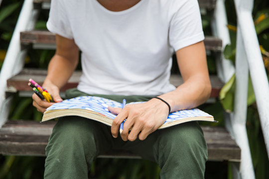 Young creative creating art in his notebook