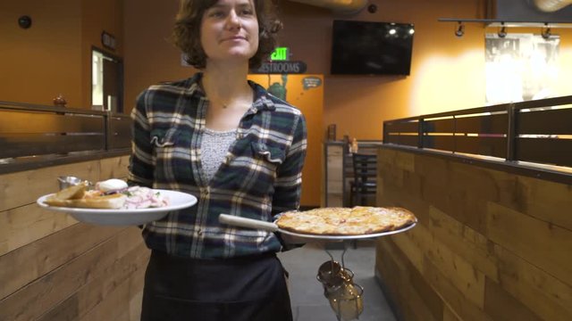 Waitress welcoming people to a bar