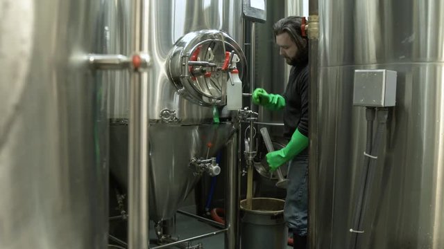 Man pulling a pallet jack full of beer kegs