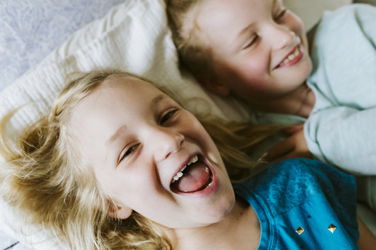 Young sisters laughing and playing together