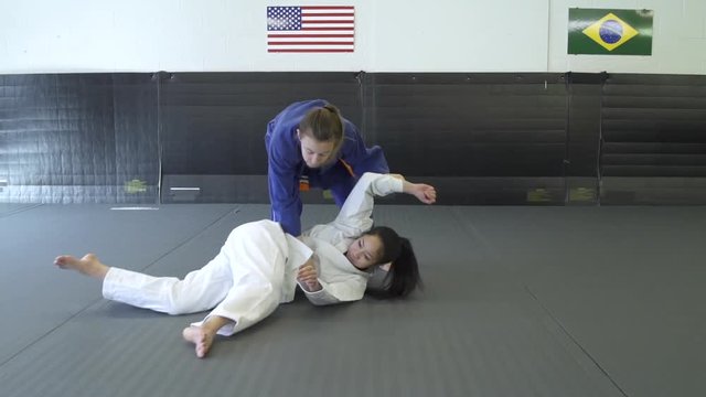 Teenage girls practicing Jiu-jitsu
