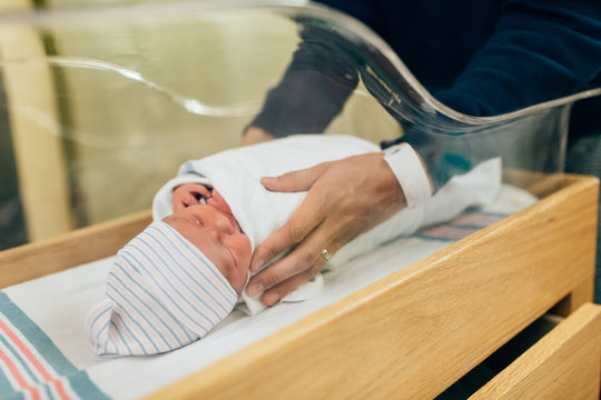 swaddling newborn baby