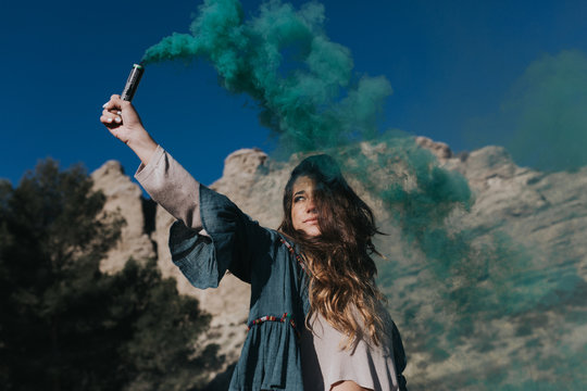Female holding smoke bomb