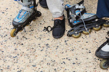 Woman putting on roller skates outdoor.
