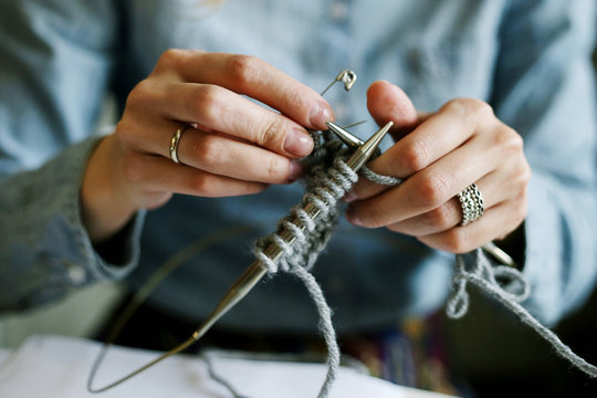 Girls hands knitting close up