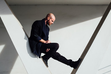 Smart Casual Caucasian Man Against Concrete Structure