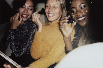 Diverse women in a backseat of a cab