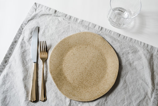 Neutral minimalist dinnerware plate styling on white table