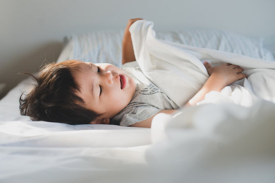 Toddler resting in bed