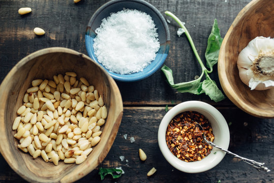 Pine nuts, salt, red pepper flakes and garlic