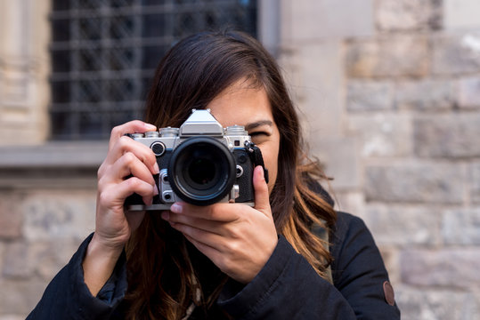 Young woman shooting on camera