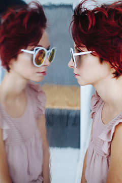 Stylish model reflecting in mirror