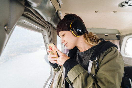 Woman Taking Photo While Flying Inside Small Plane