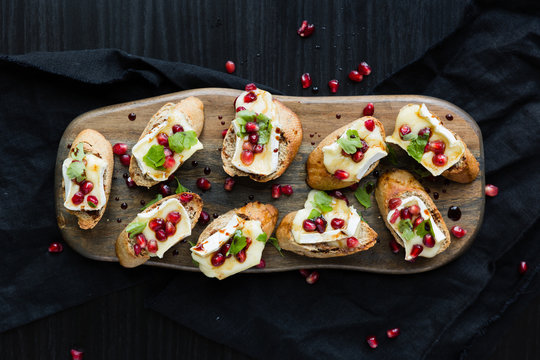 Brie and Pomegranate Crostini on serving board