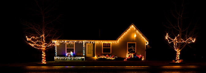 A classic little Christmas cottage with the basic Christmas light theme.