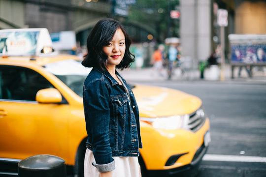 Woman waiting for taxi in city