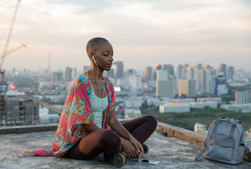 Woman listening to the guided meditation on her headphones