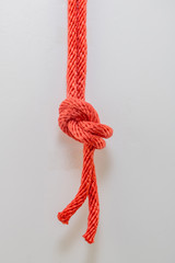 Close up red rope knot on a white background.