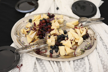 Fruit and Cheese on a Silver Platter on a white Lace Tablecloth