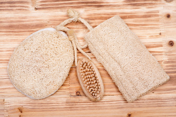 Natural bristle hand and nail wooden brush and loofah sponge on wooden vintage background