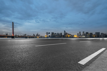 Fototapeta na wymiar Empty asphalt road through modern city at dusk, China