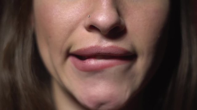 A woman bites her lips impatiently