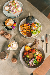 Multicolored delicious veggie dishes on the table in a cafe. Dishes only from vegetables. Healthy food