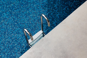 Stairs down to the pool Blue tile swimming pool.
