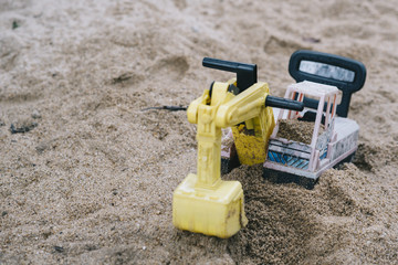broken toy on sand