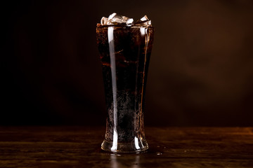 Glass of cold refreshing cola soft drink