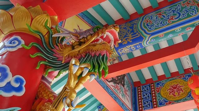 Slow motion of The colourful giant Chinese dragon sculpture in the temple