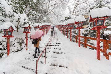 Stone stair and traditional light pole with snow fall in winter at Kifune shrine , Kyoto prefecture , Japan