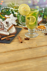 mulled wine with gingerbread cookies on wooden table