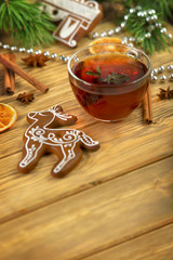 mulled wine with gingerbread cookies on wooden table