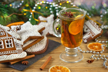 mulled wine with gingerbread cookies on wooden table