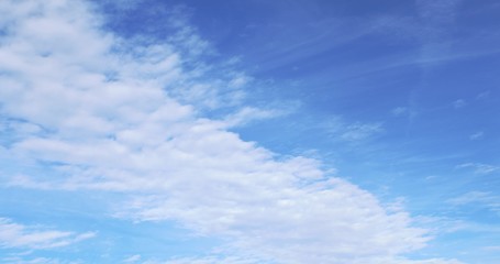 Thin, wispy ,white Cirrus clouds floating on a cold, brilliant winter sky with tints of blue