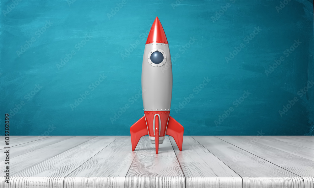 Poster 3d rendering of a red and silver realistic model of a retro rocket stands on a wooden desk on a blue