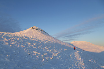 Pen y Fan and Corn Du are the highest mountains in the Brecon Beacons National Park - winter snow scene with blue sky at dusk. - obrazy, fototapety, plakaty