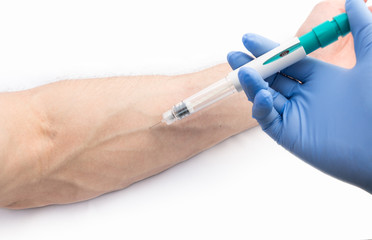 A nurse making injection into a vein