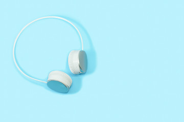 Wireless headphones isolated on light blue background. bluetooth