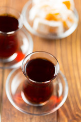 Red tea in turkish glasses on a wooden table