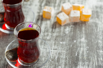Red tea in turkish glasses on a wooden table
