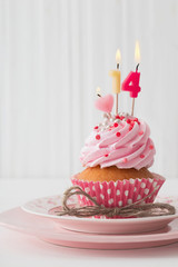 pink cupcake on white wooden background