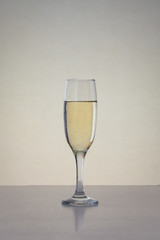 One glass with champagne on the table