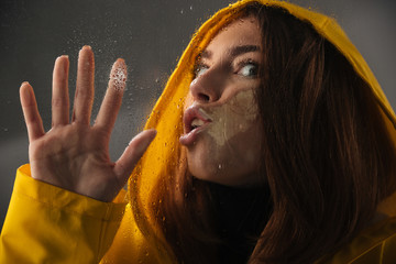 Close up of a funny girl dressed in raincoat