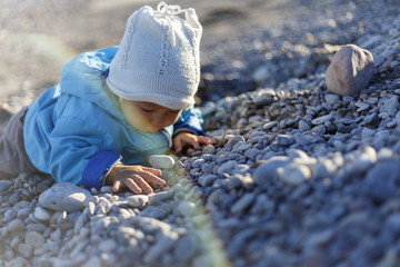 A boy is playing on a beach