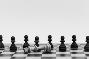 Chess pieces on a chess board with the king and pawns